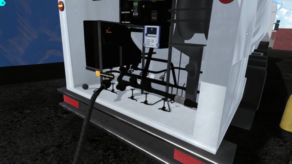 In petroleum safety training simulator, close-up of a petroleum transport truck's rear in a virtual simulator, highlighting fuel dispensing hoses, valves, gauges, and digital controls within an industrial training environment.